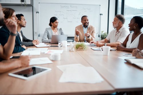 Business people, teamwork and meeting for strategy, planning or corporate brainstorming discussion at office. Group of employees in team collaboration or communication in conference at the workplace.